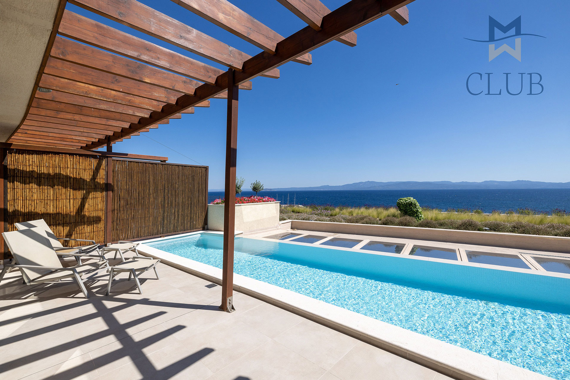 Private terrace of suite with private pool, sun loungers, bamboo wall dividers and wooden pergola