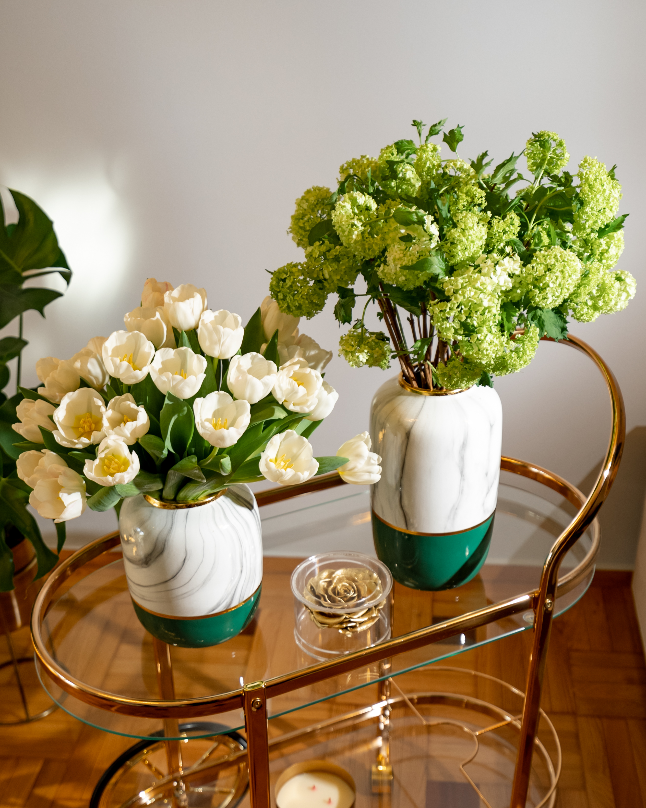 Modern glass table decorated with elegant vases and beautiful white flowers