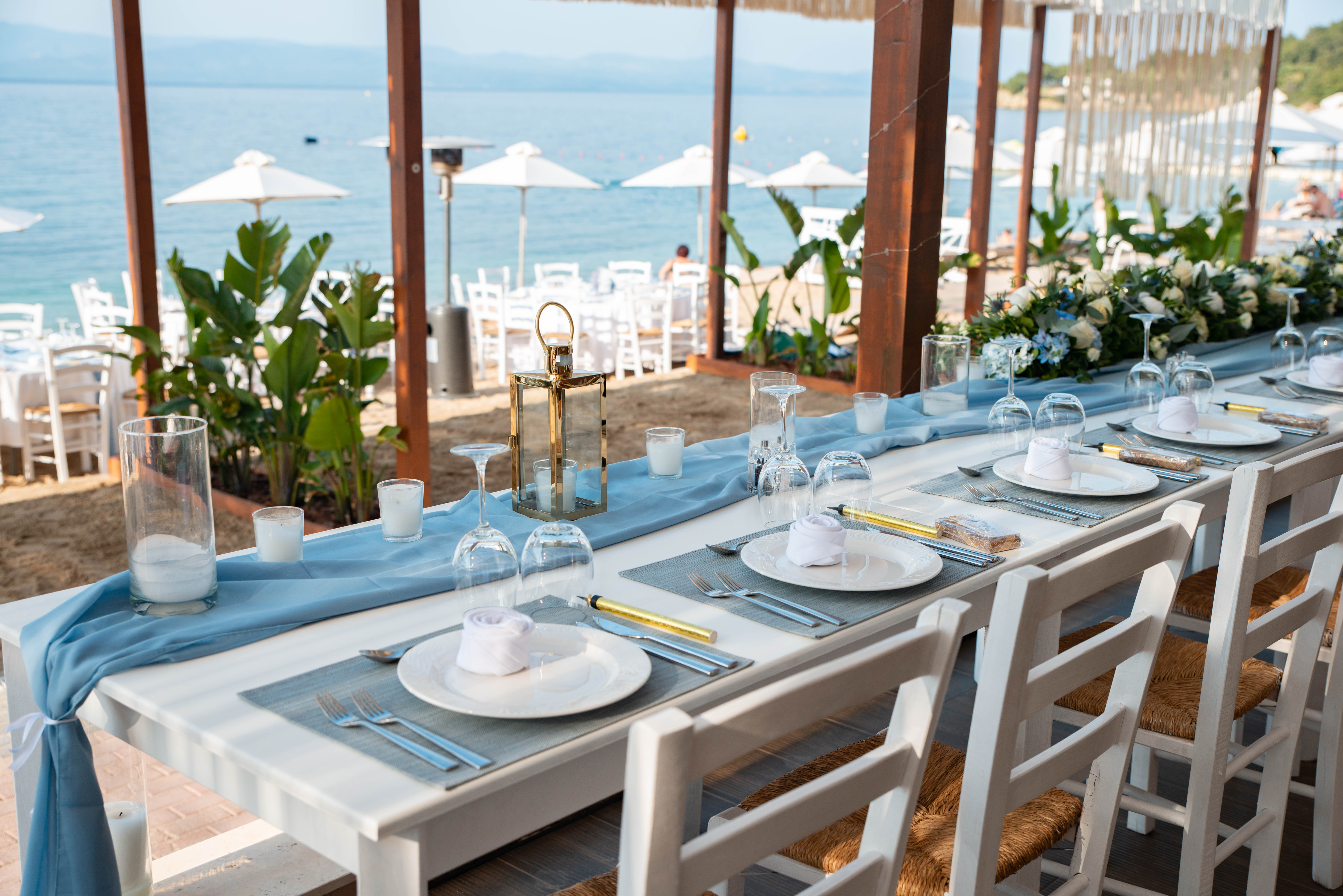 Beachfront wedding dinner setup with elegant table and sea view