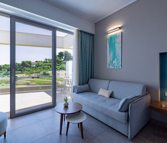 Deluxe Side Sea View sofa, chair and balcony door