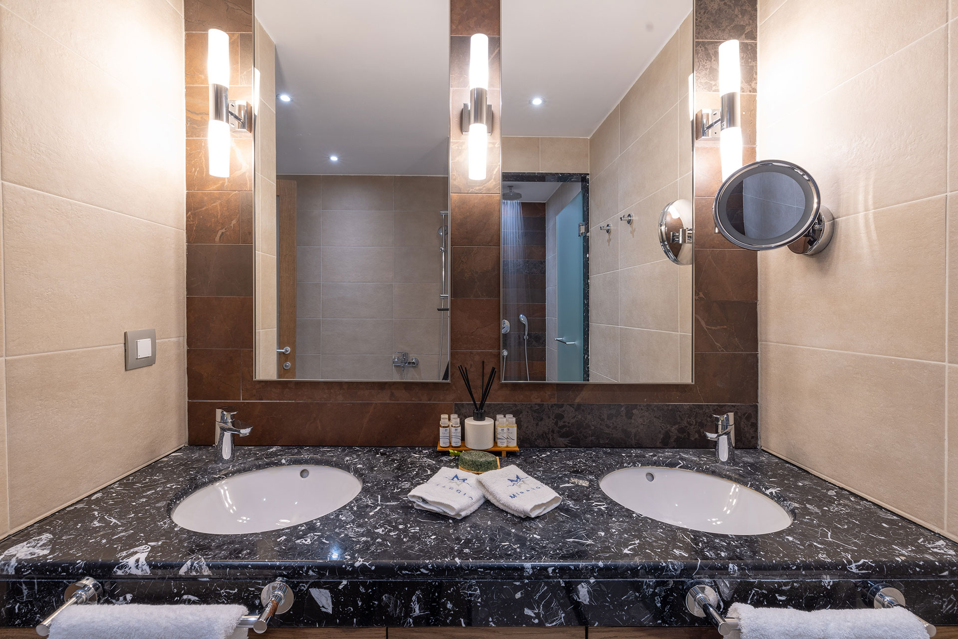 Family room stylish bathroom with twin basins, marble countertop, huge mirror and vanity