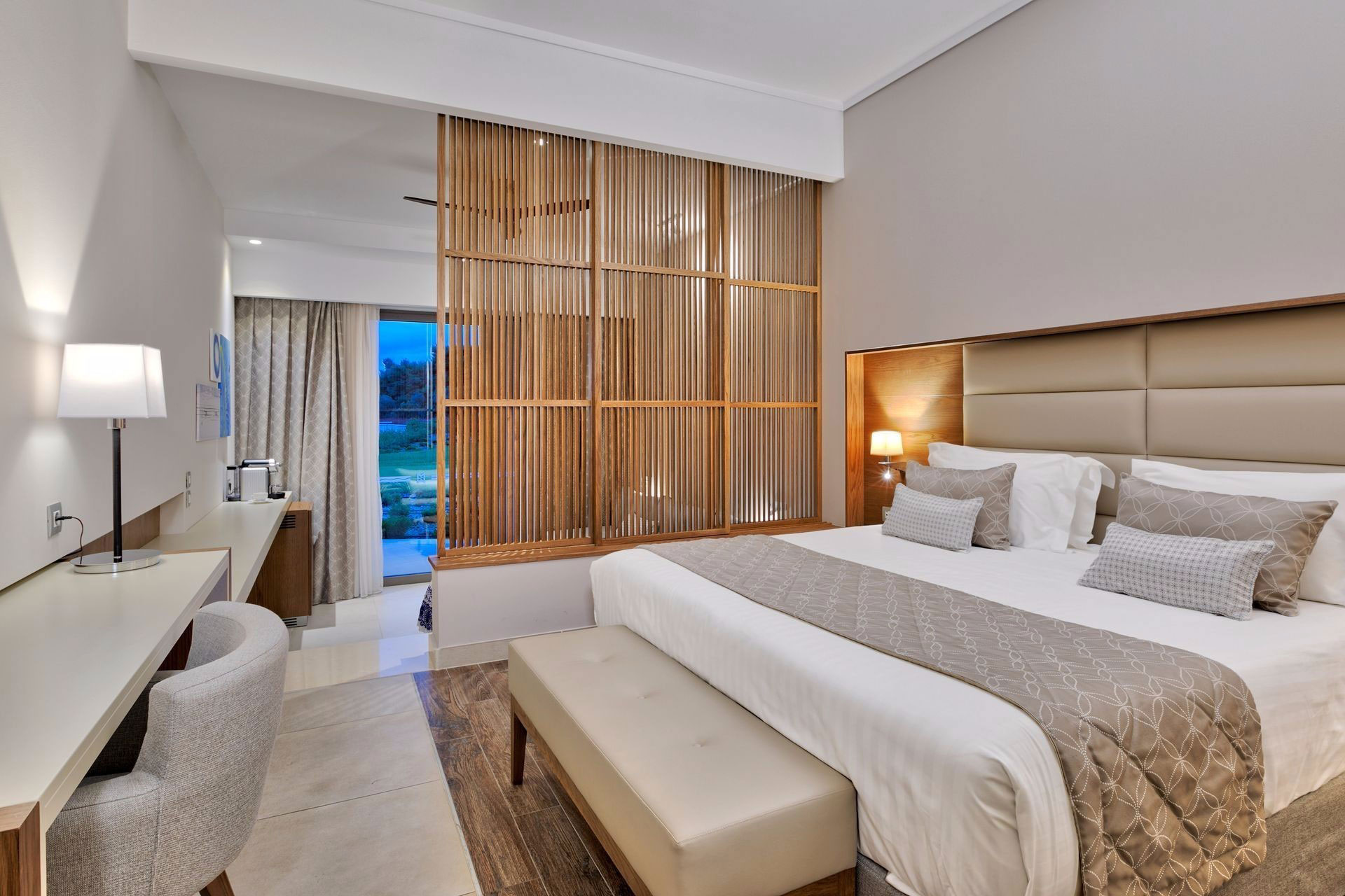 Family room with elegant neutral tones, wooden divider, and garden access