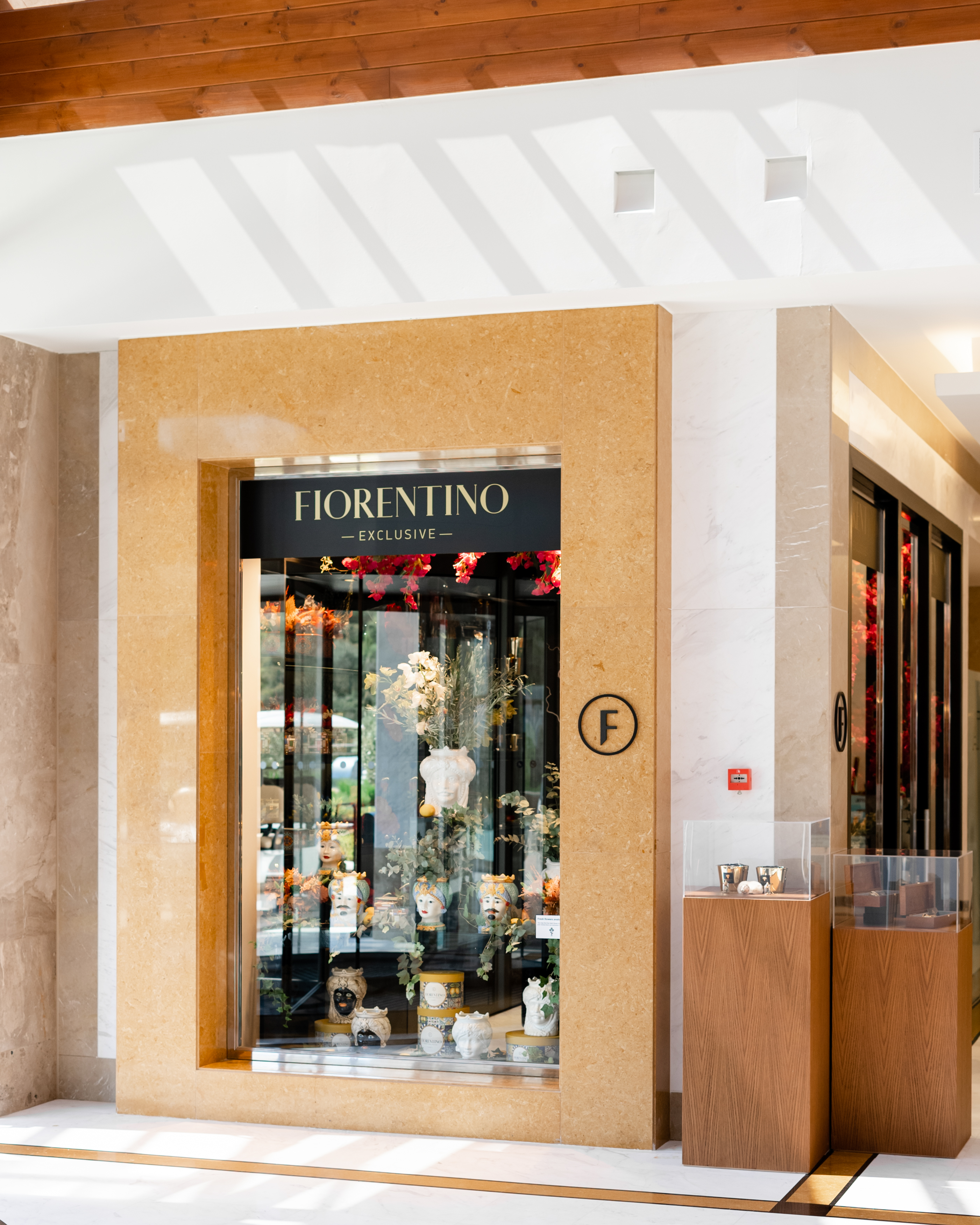 Fiorentino storefront with glass panels and elegant flowers arrangement in modern vases