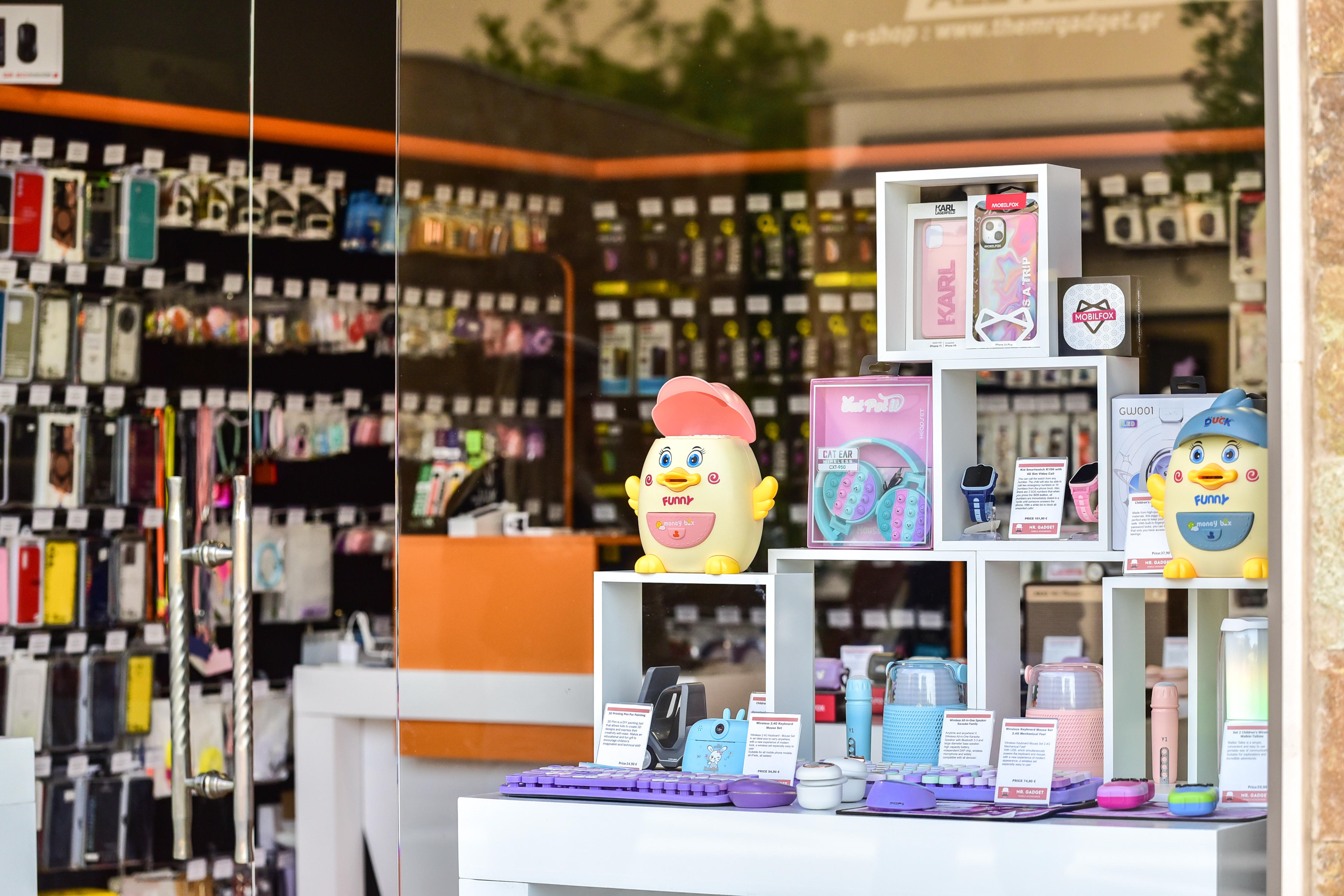 Colorful tech gadgets, headphones, and phone accessories displayed in playful setup