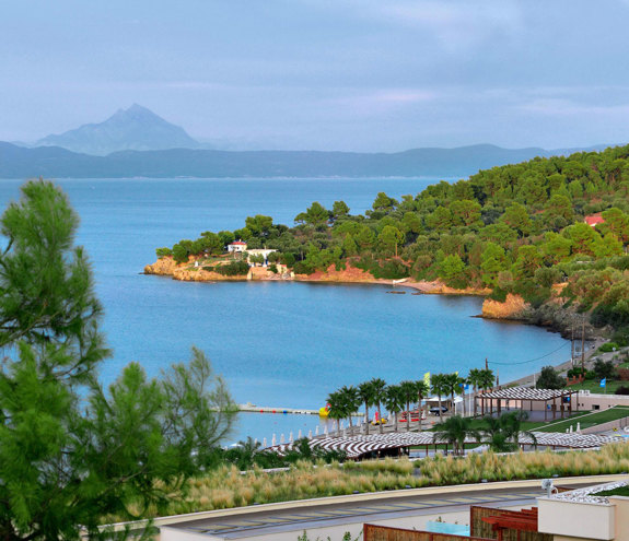 Panoramic view of Miraggio beach and lush coastline overlooking mount Athos