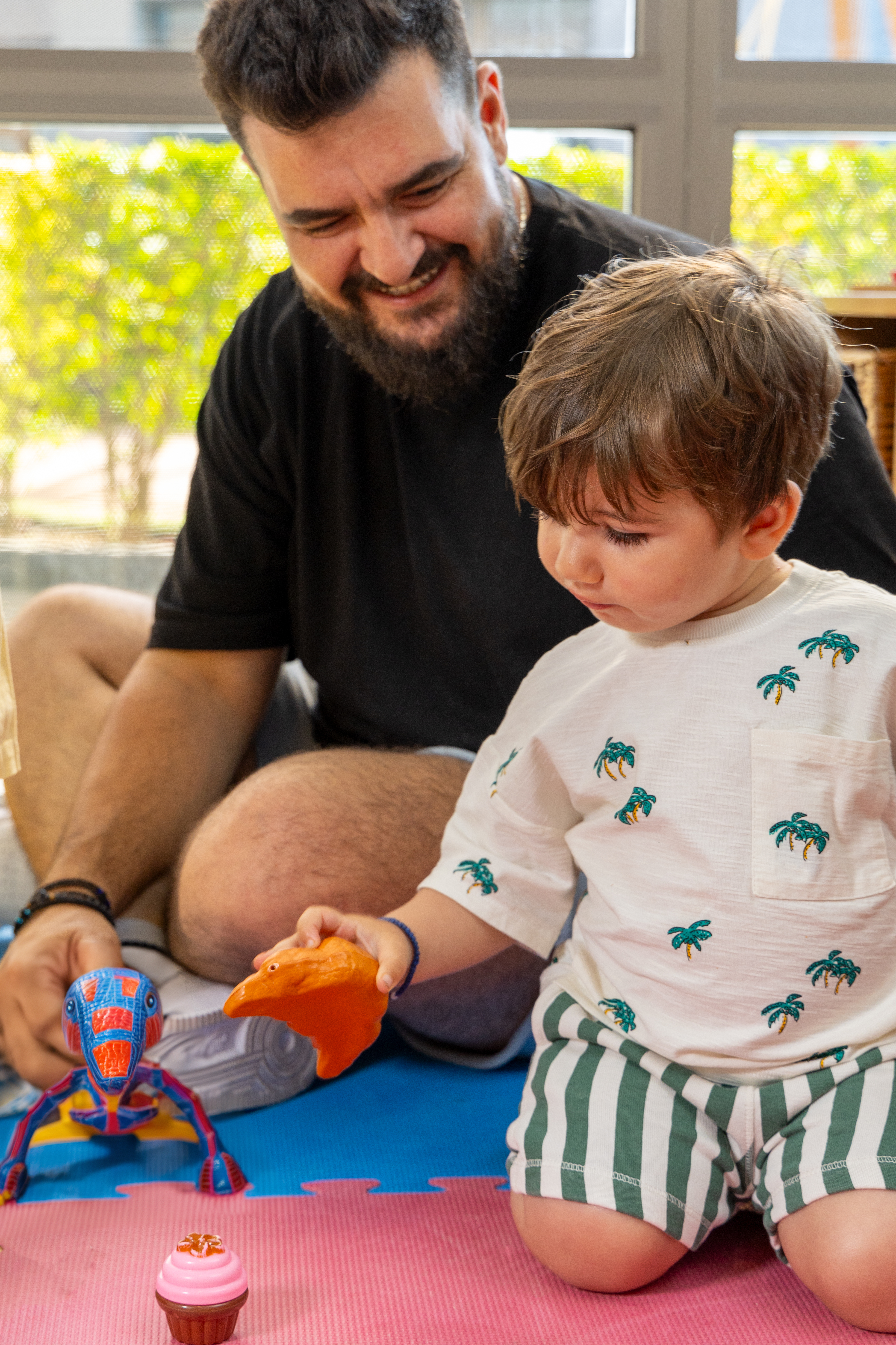 Father and son playing with toys in the indoor playground of Kids Planet