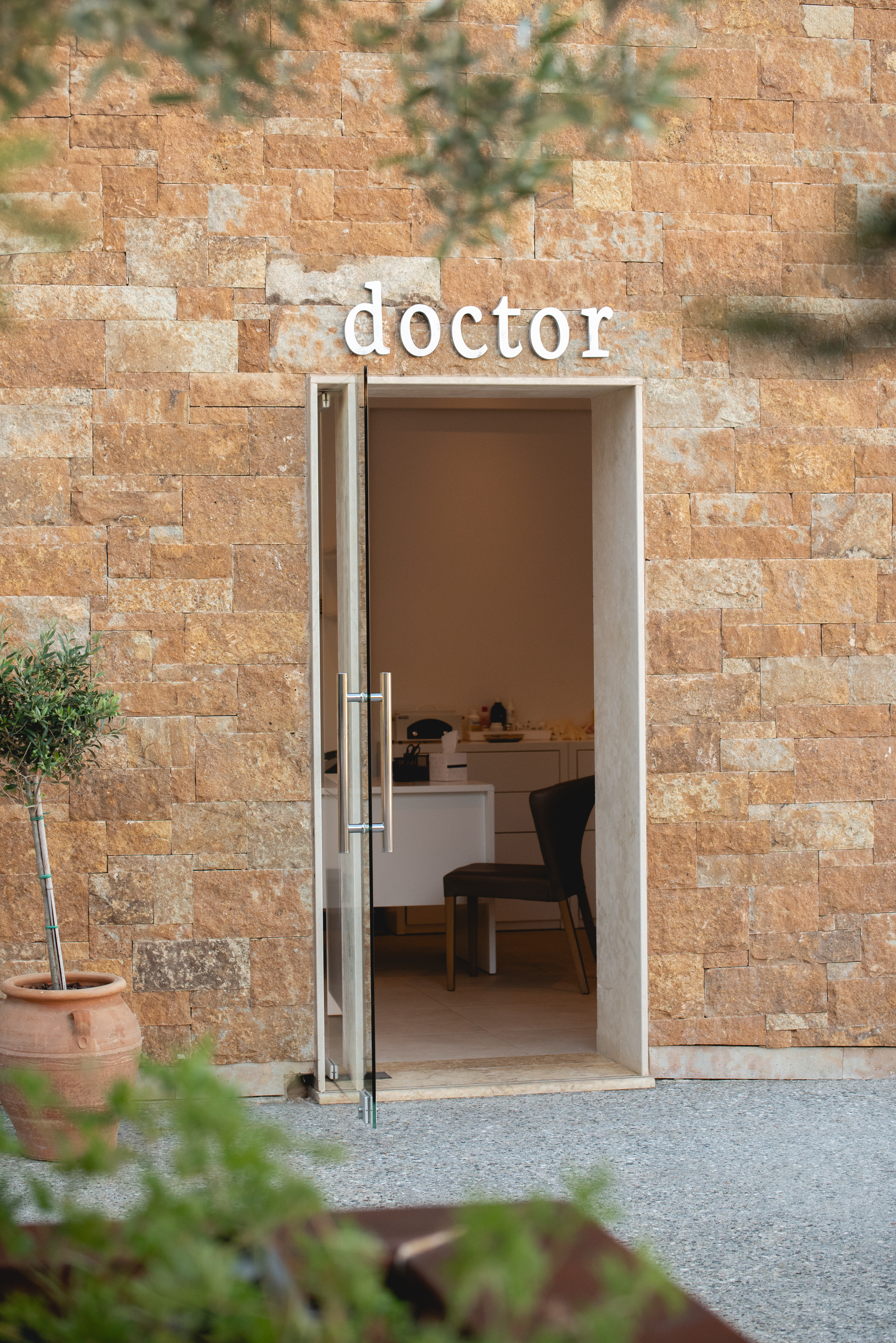 Entrance to the resort's medical office with doctor sign on a stone wall
