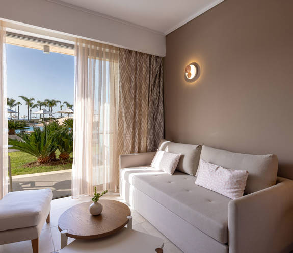 Deluxe Pool Front Room sofa and balcony view
