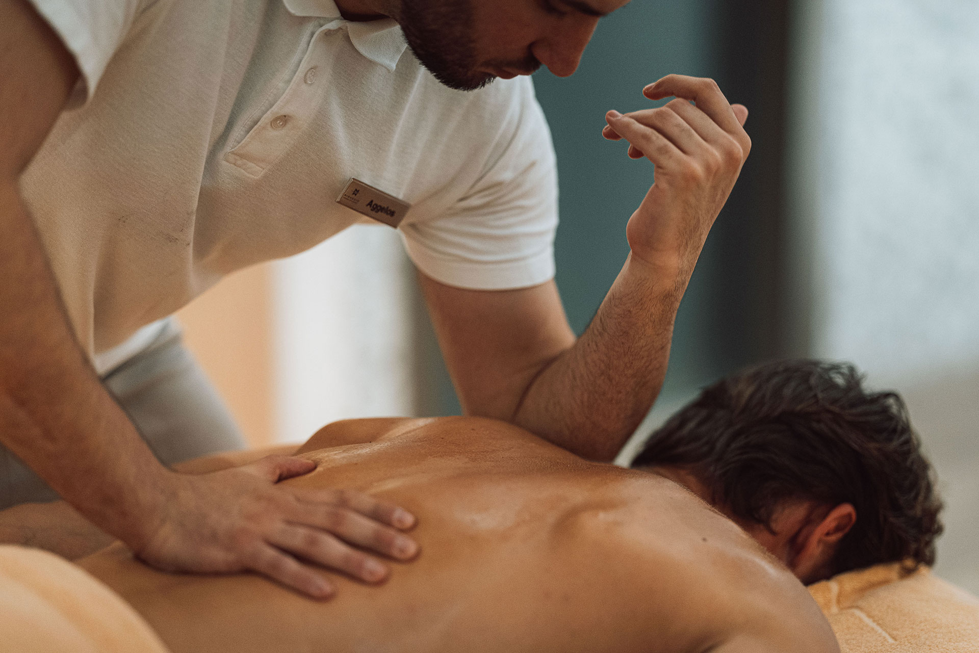 Therapist performing relaxing back massage in a serene spa room