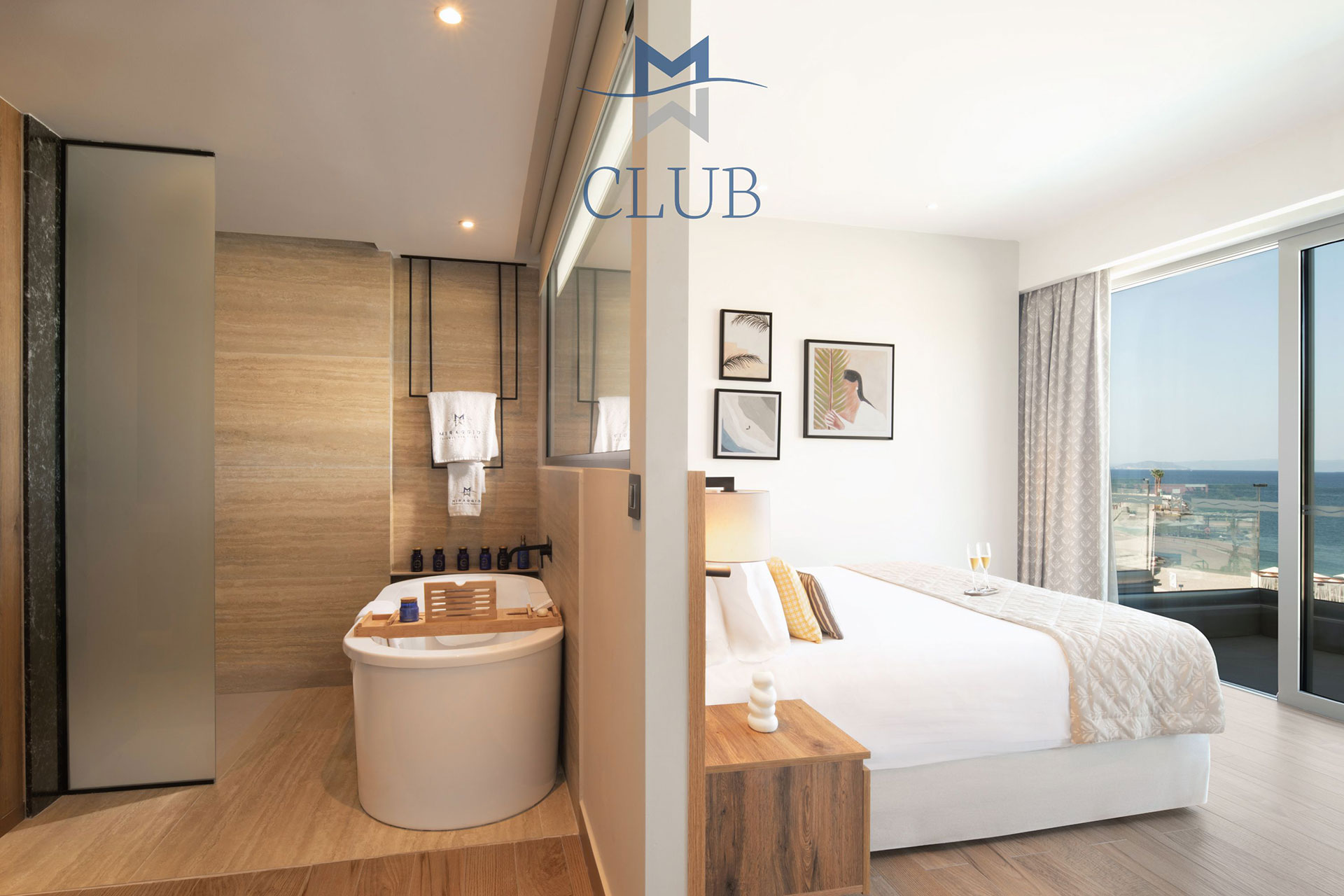 Wide view of duplex suite's bedroom and bathroom with double bed and warm lighting