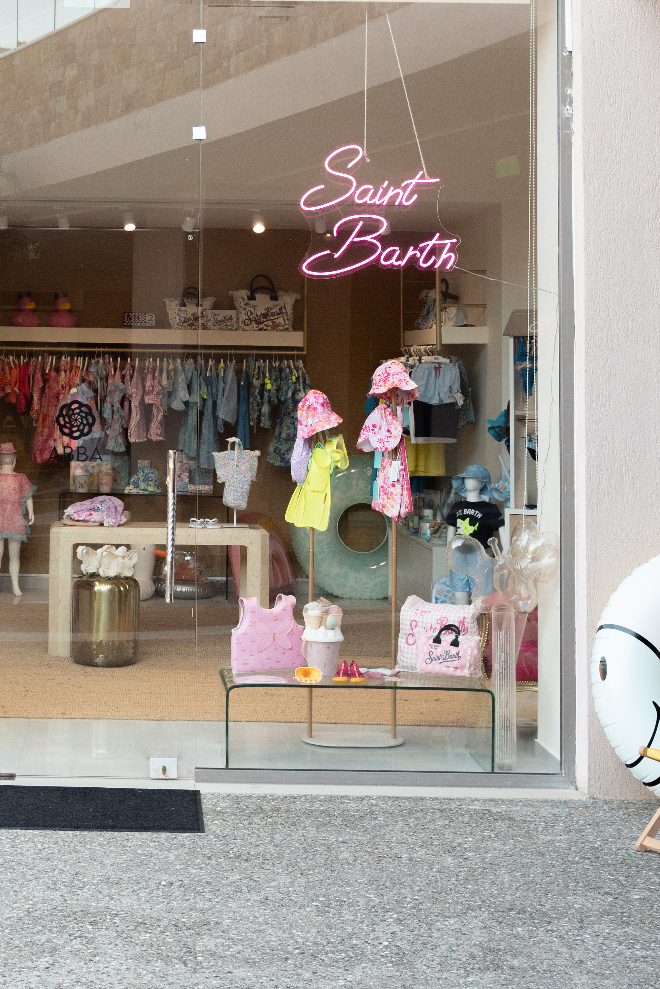 ABBA boutique with children's clothing, accessories, and a pink neon sign