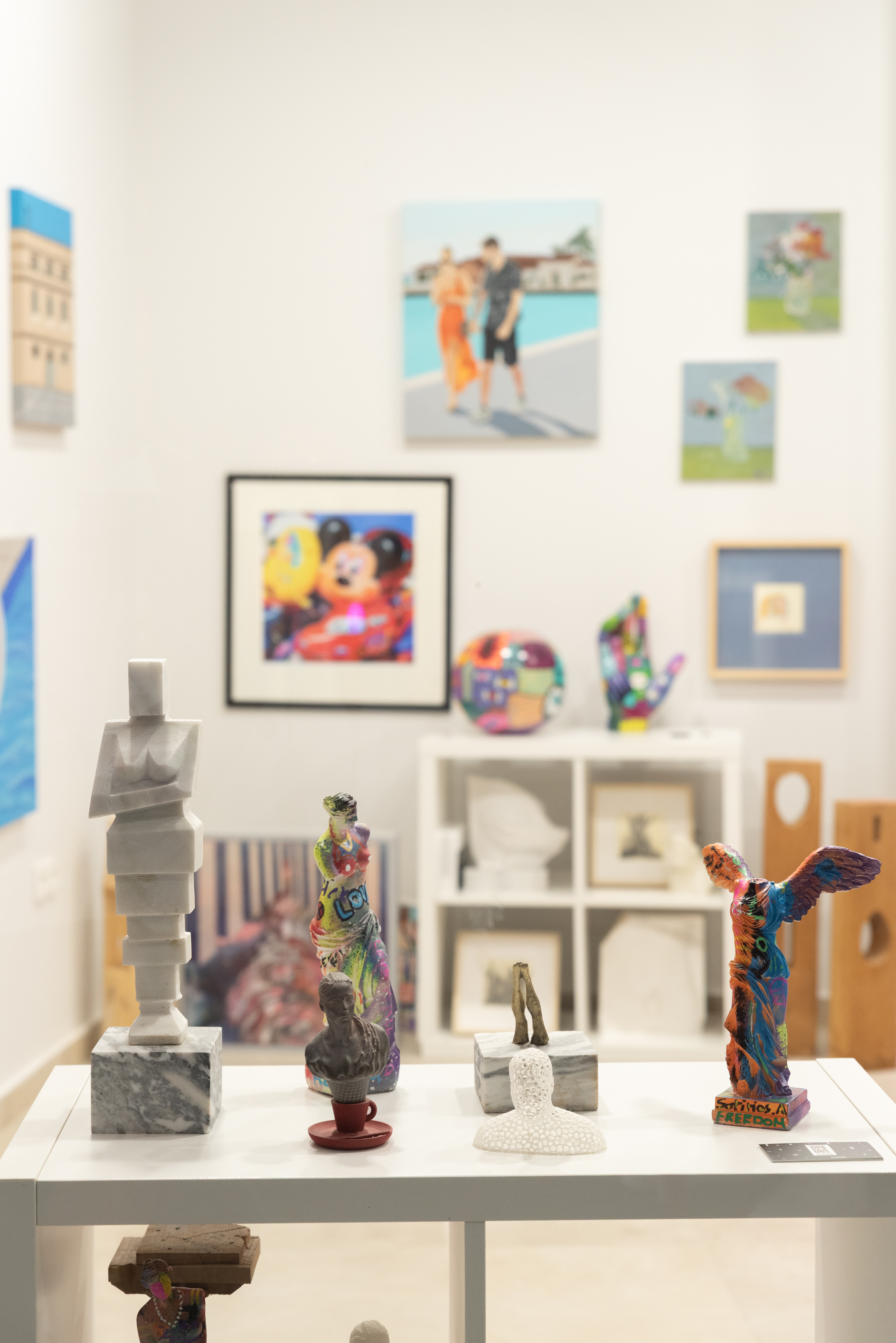 Close up to small figurines painted with modern colorful accents 