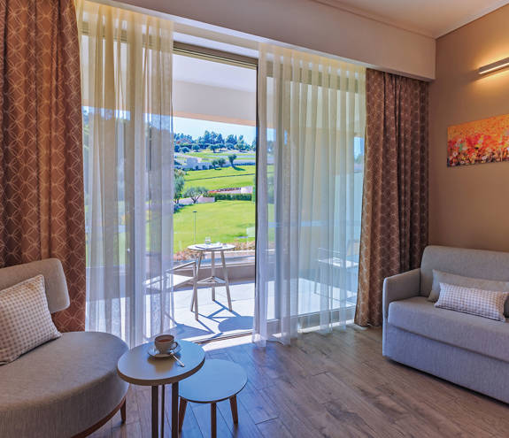 Superior Garden View Room armchairs and view of the balcony