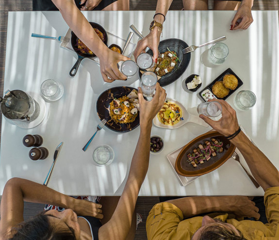 A group of friends enjoying their time at Mezedaki Beach Restaurant