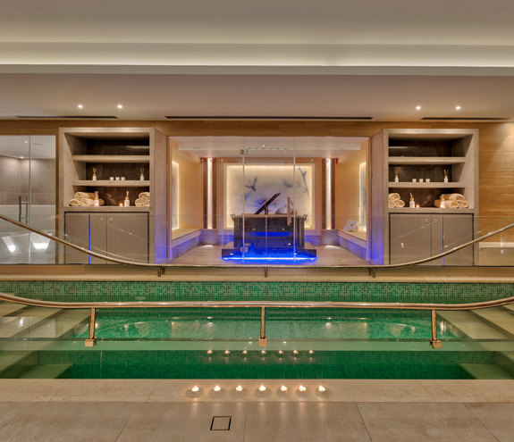 Interior walking cold-plunge pool with handrails and ambient lighting