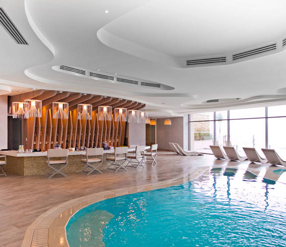 Myrthia Health Bar chairs, bar, pool and sunbeds