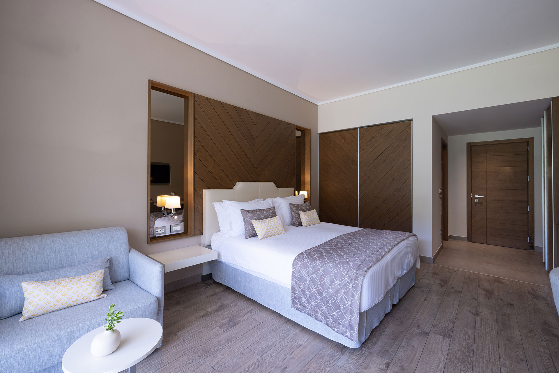 Elegant room with king bed, soft lighting and contemporary wooden details