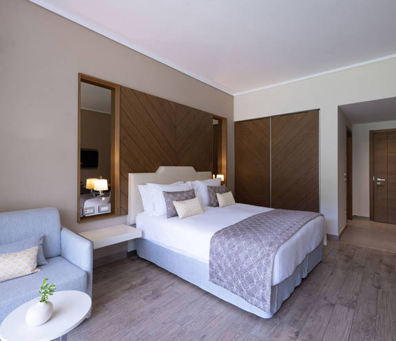 Superior Garden View Room armchair, table and bed