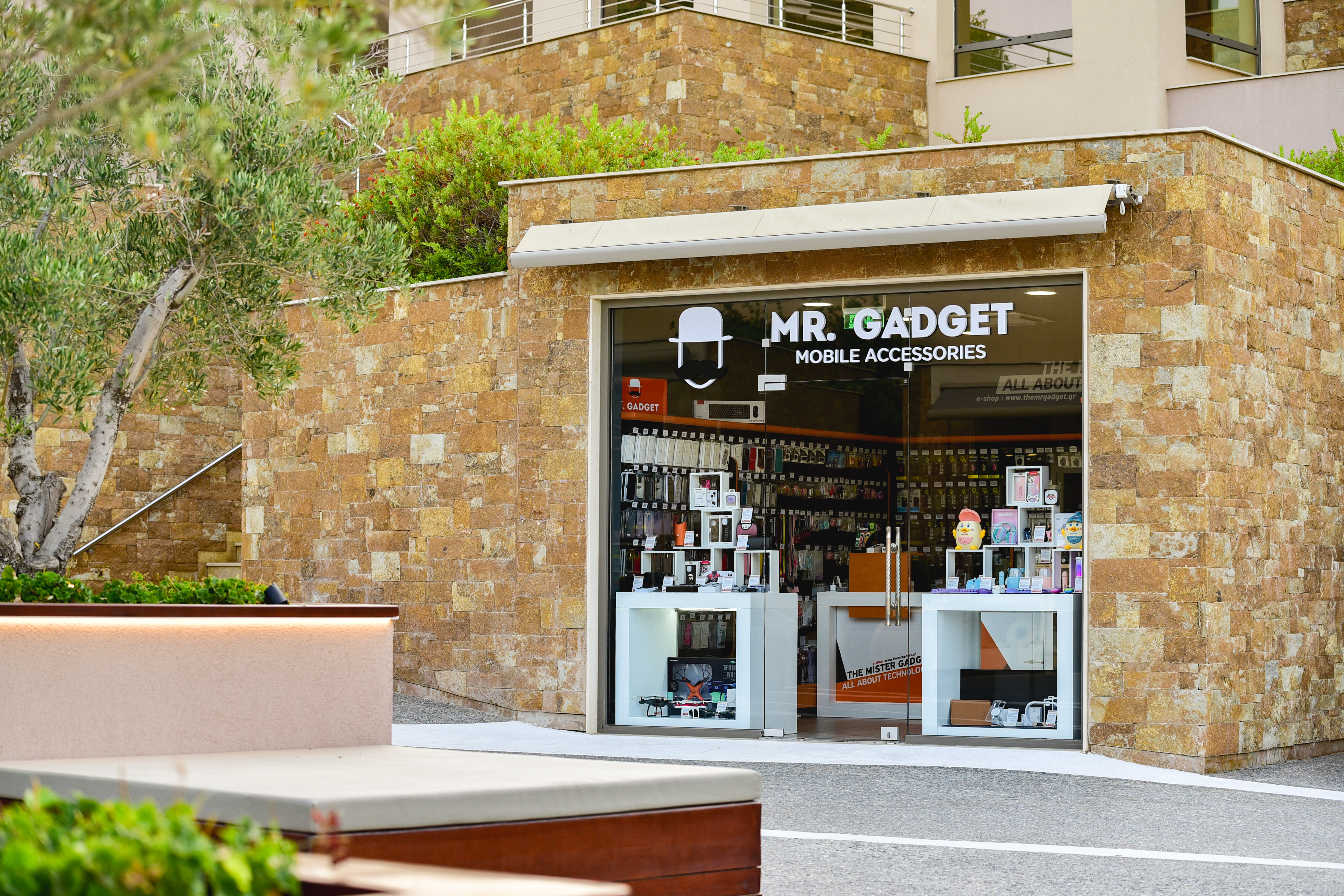 Modern storefront of Mr. Gadget shop displaying mobile accessories and gadgets
