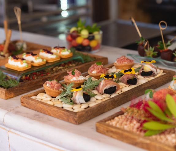Gourmet wedding appetizers and canapes beautifully arranged on wooden trays