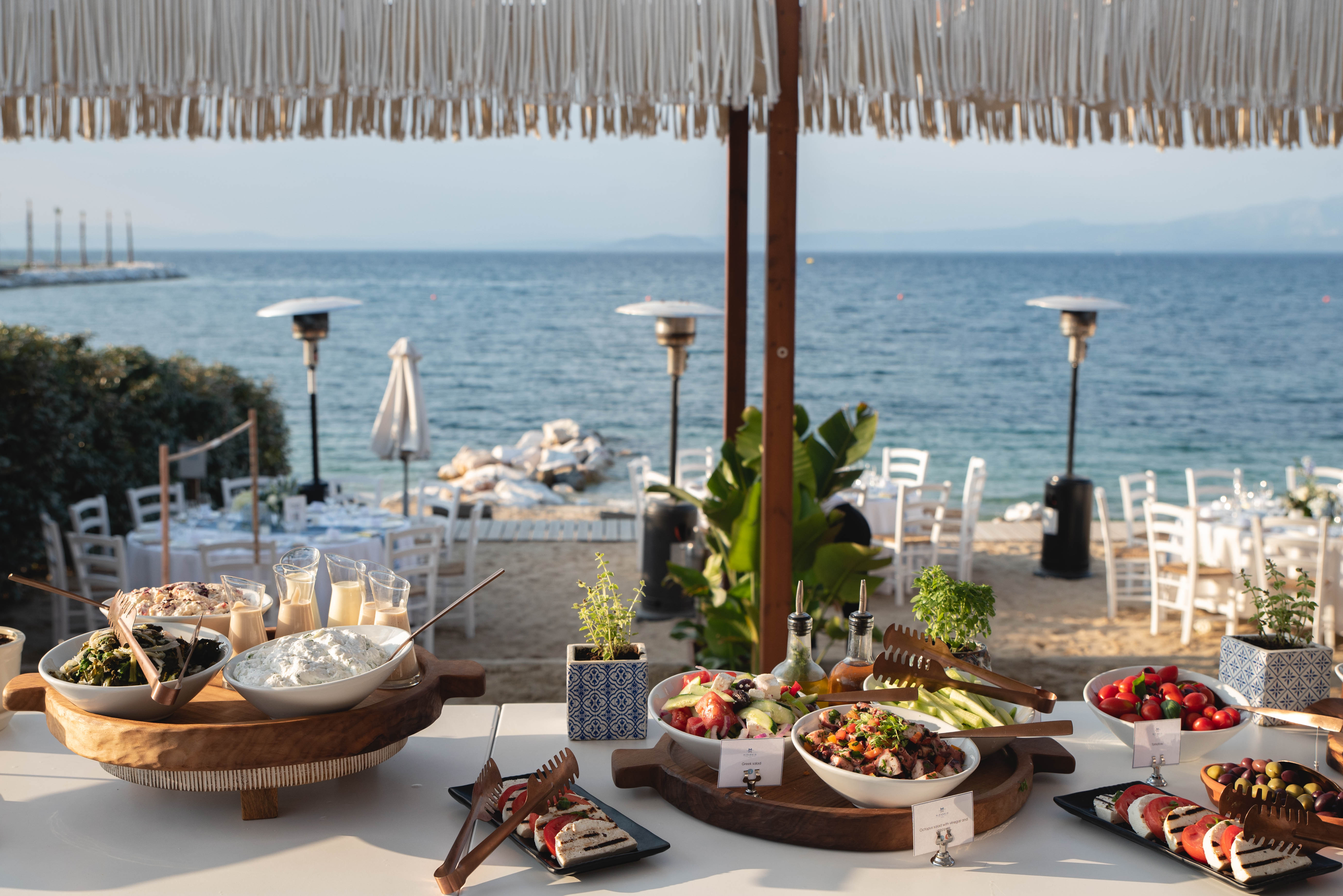 Elegant wedding buffet featuring salads and cheeses near the beach