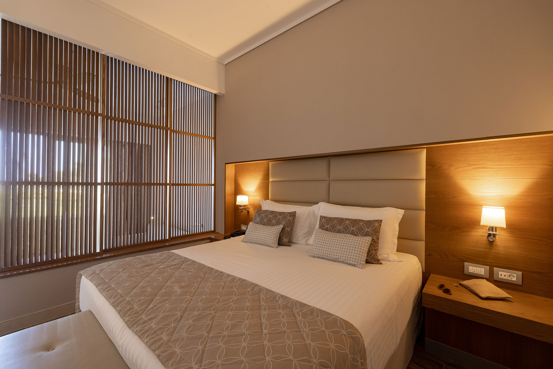 Family room with king-size bed, warm lighting, and wooden decor accents