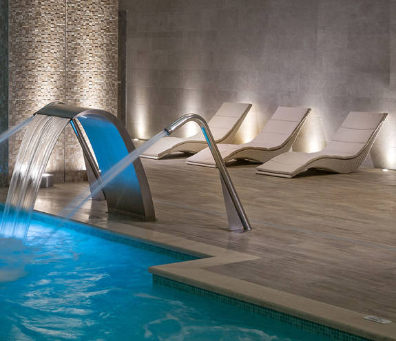 Myrthia Thermal Spa pool's waterfalls and sunbeds