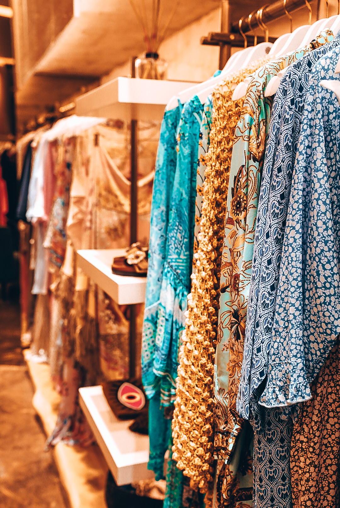Colorful summer dresses on display inside elegant boutique