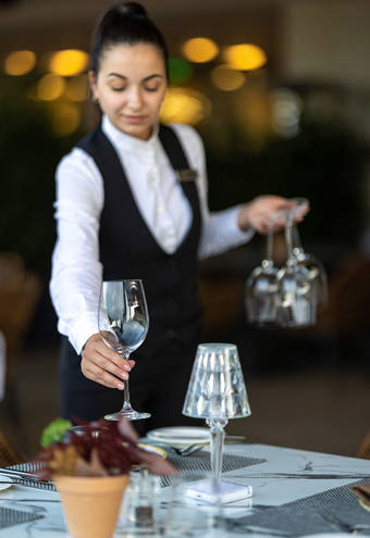 Sommelier's Restaurant waitress preparing a table