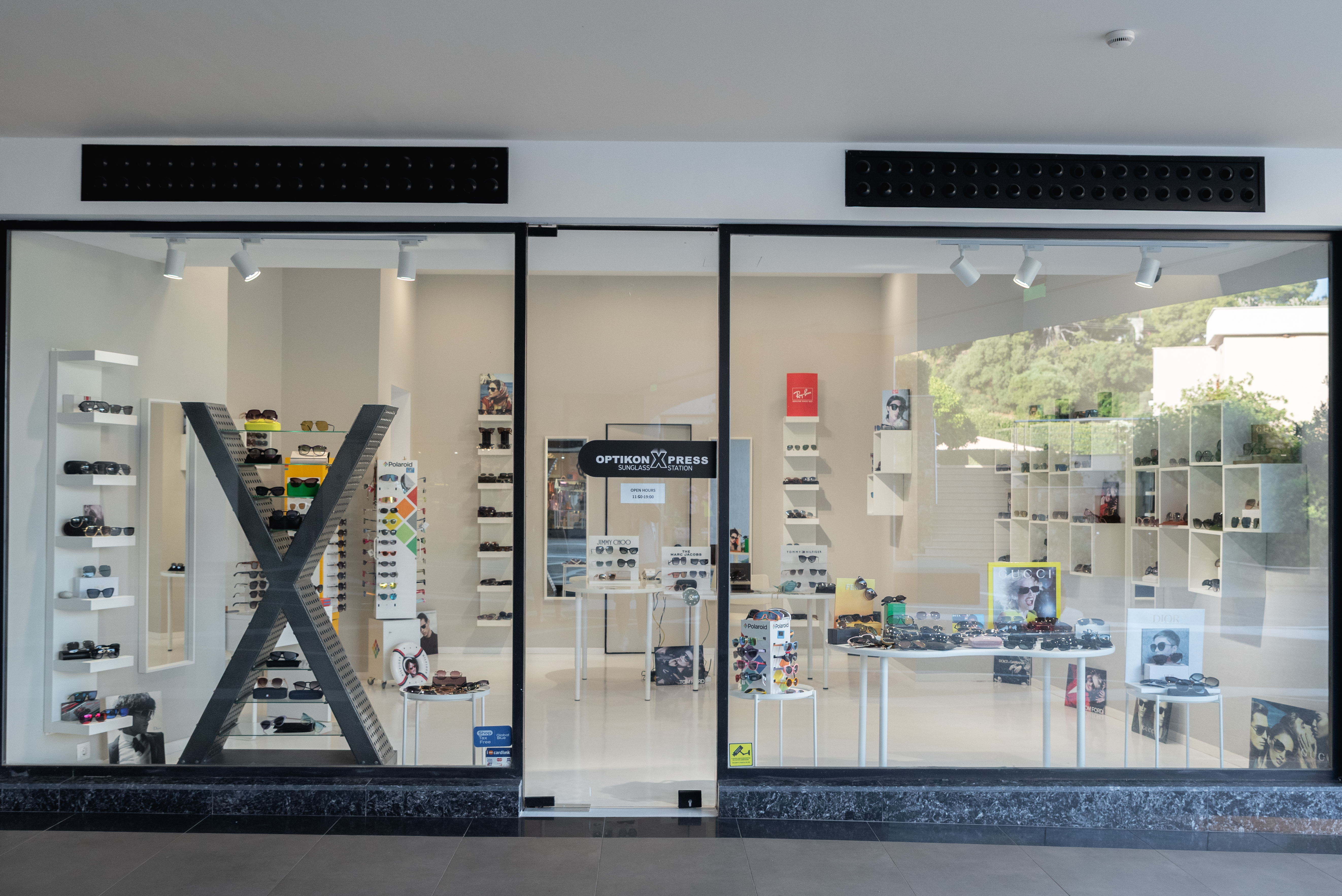 Optikon Xpress store front showcasing a wide selection of designer sunglasses