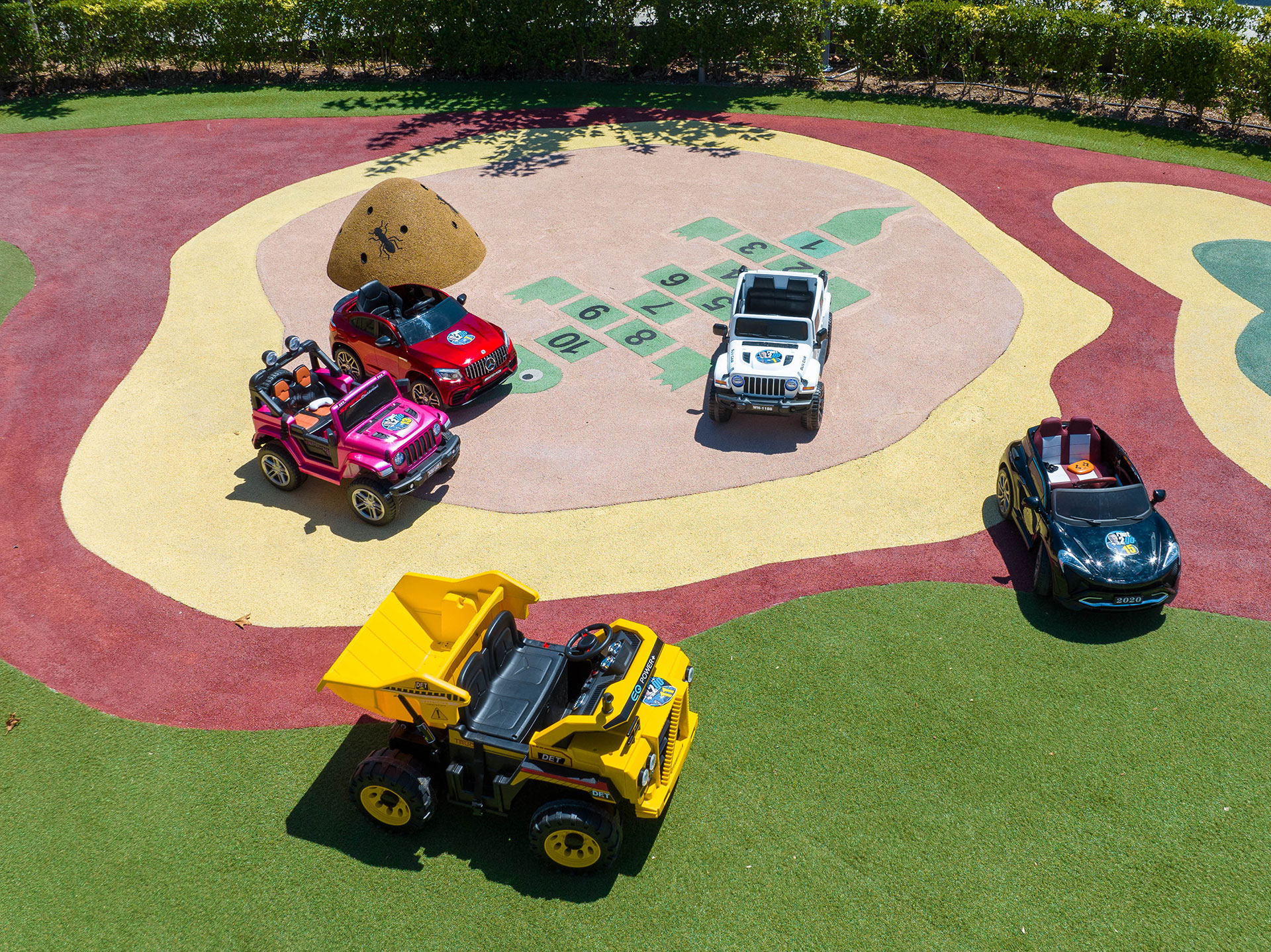 Big car toys in the outdoor play area of Kids Planet