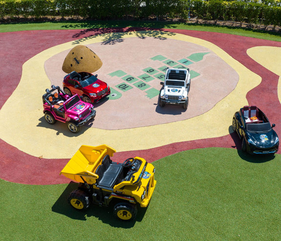 Big car toys in the outdoor play area of Kids Planet