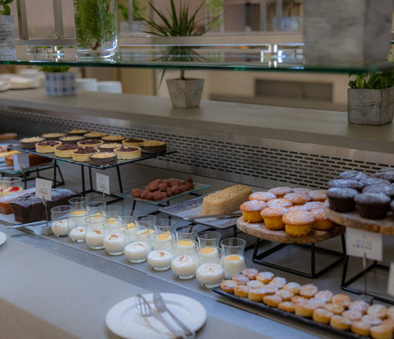 Close up to dessert buffet featuring cakes, biscuits and mouses 
