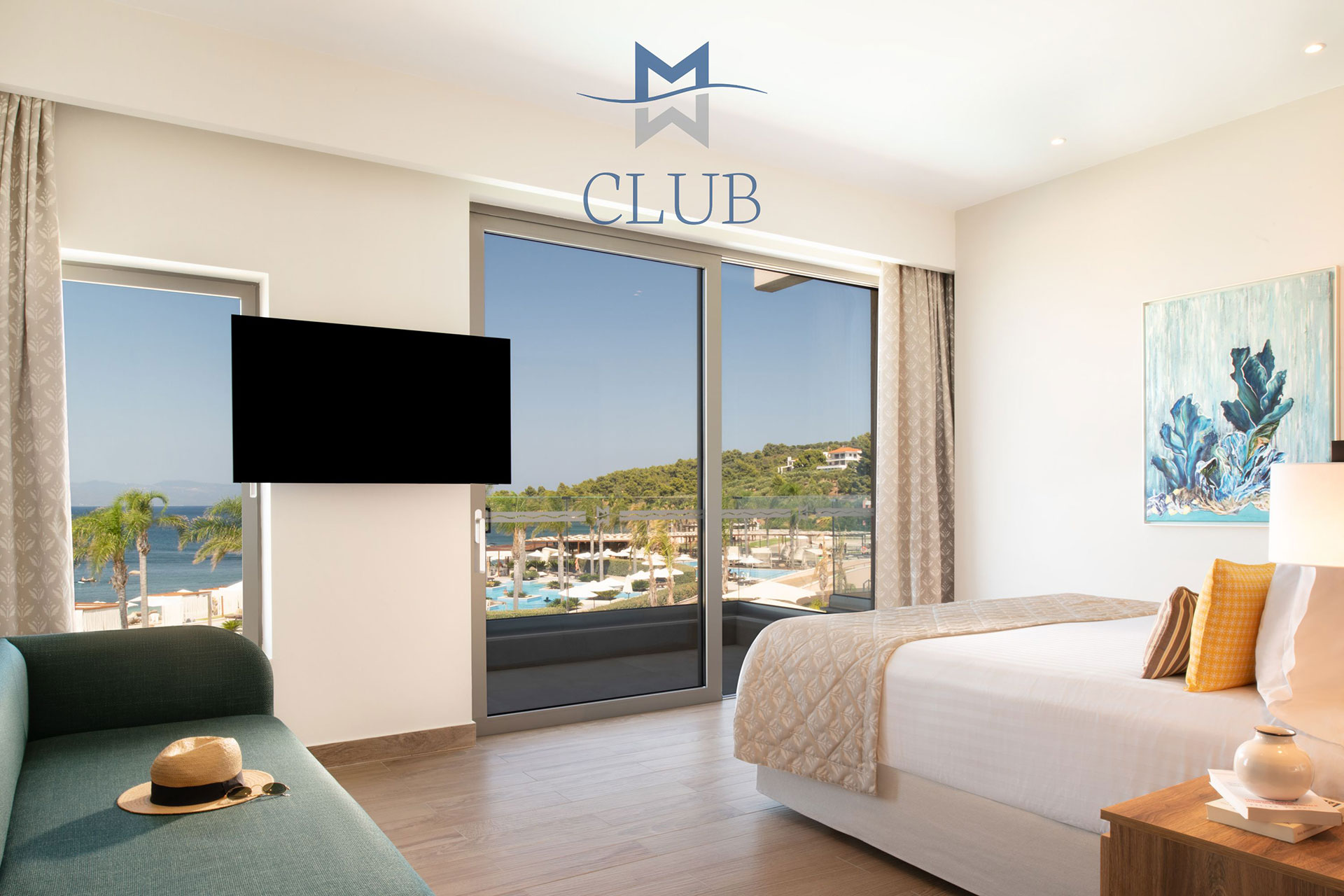 Bedroom of duplex room with glass doors with sea view, double bed and wall mounted TV