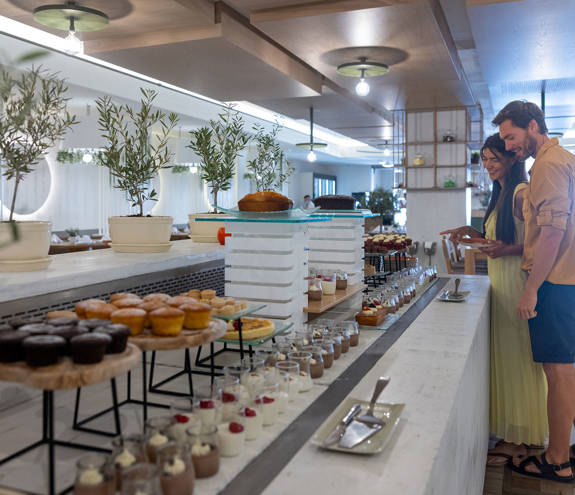 Couple picking desserts from the buffet