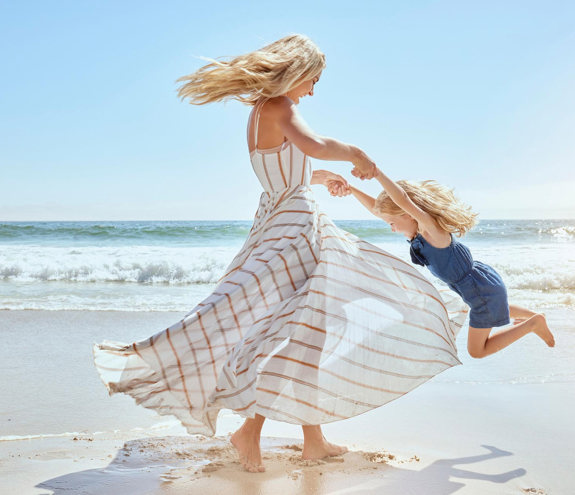 Mother and child playing at the beach