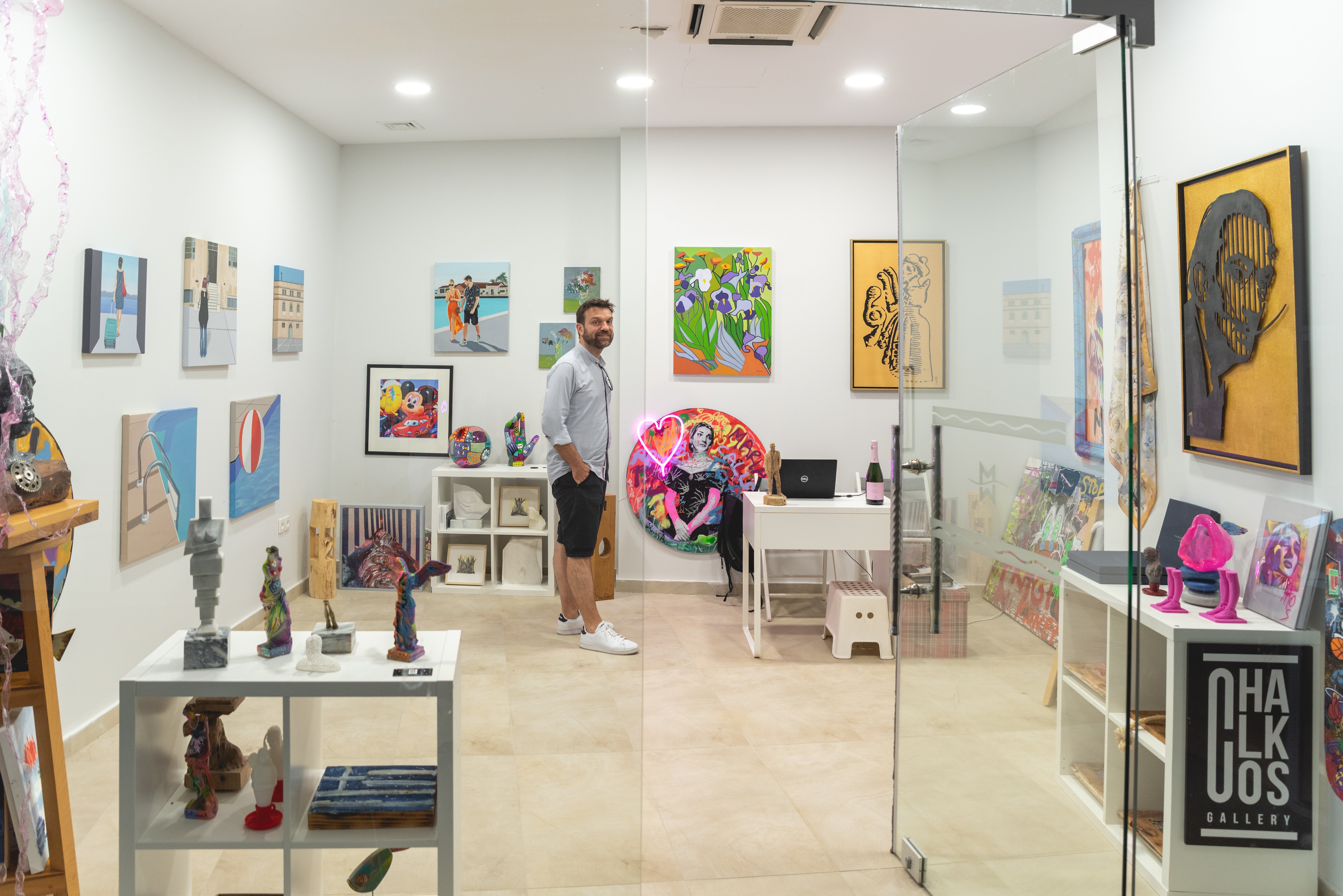 Art gallery interior with framed artworks and a man inside