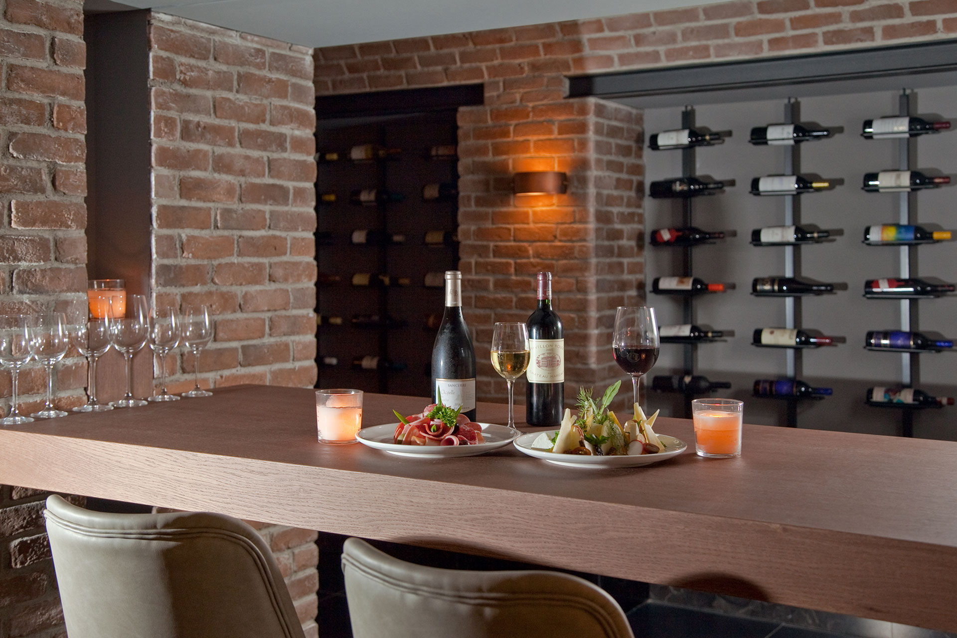 Wine tasting counter with charcuterie and cheese platters at Sommelier's 8 restaurant cellar