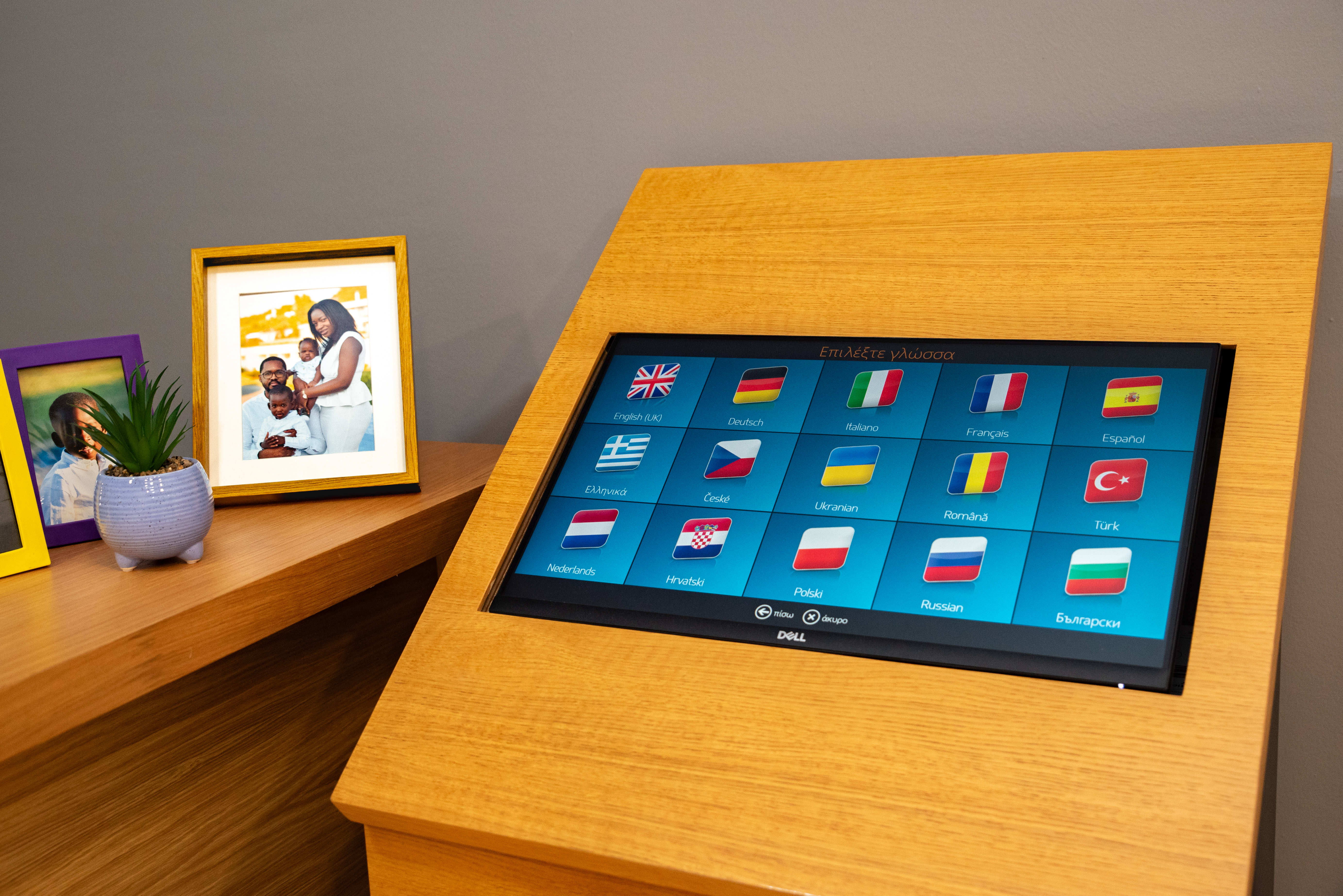 Close up of photo kiosk touchscreen with multilingual options for viewing and printing pictures