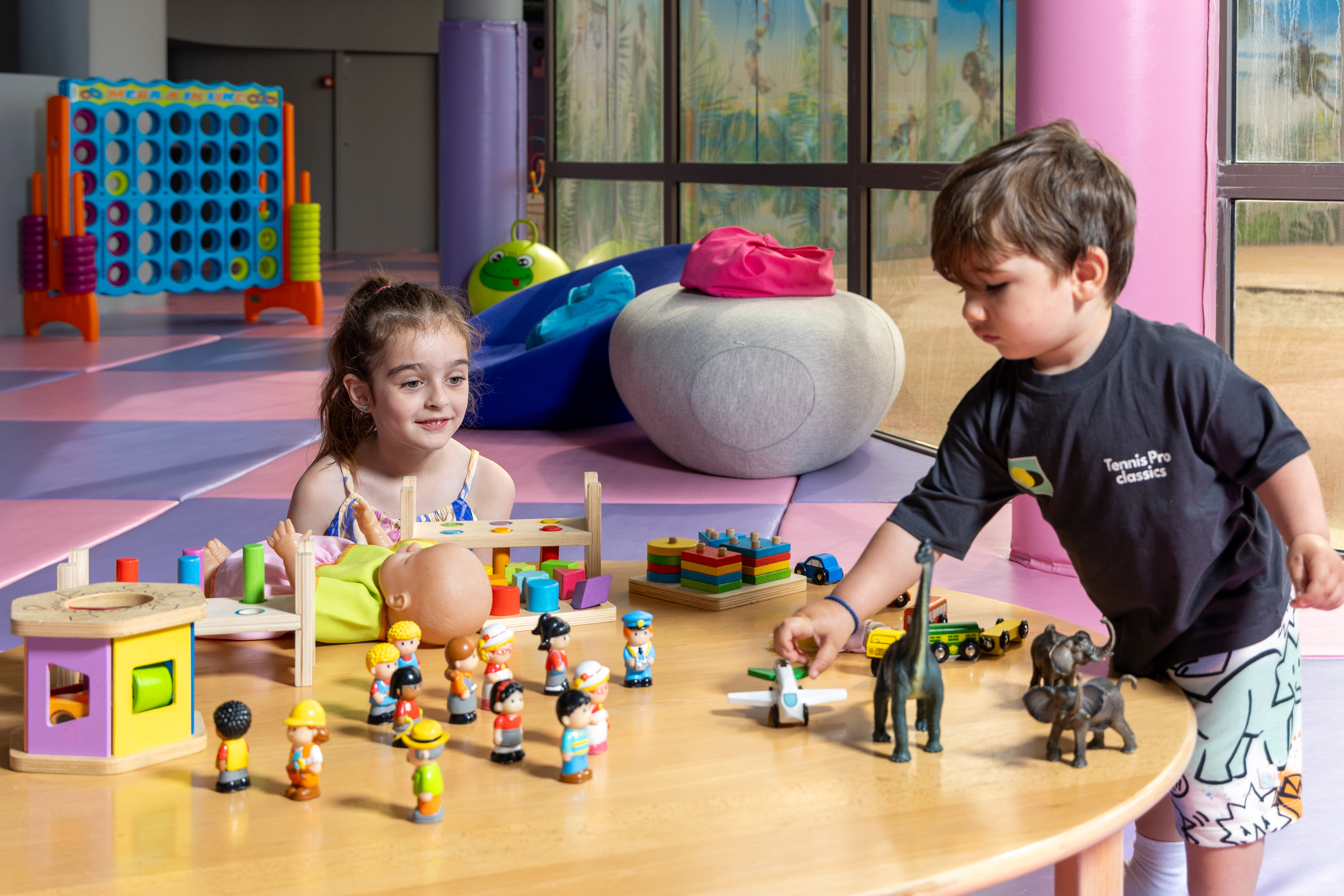Children enjoying creative play with colorful toys and figures at the Kids Planet indoor area
