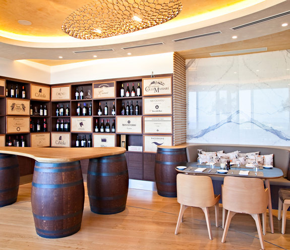 Portofino wine corner with wooden counter on wine barrels and table for wine taste