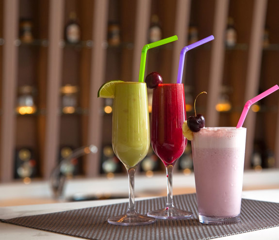 Close up of colorful handcrafted smoothies served on the counter of Myrthia Health Bar