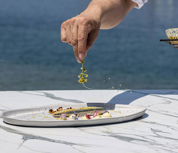 Toroneo Restaurant gourmet dish being decorated by the chef