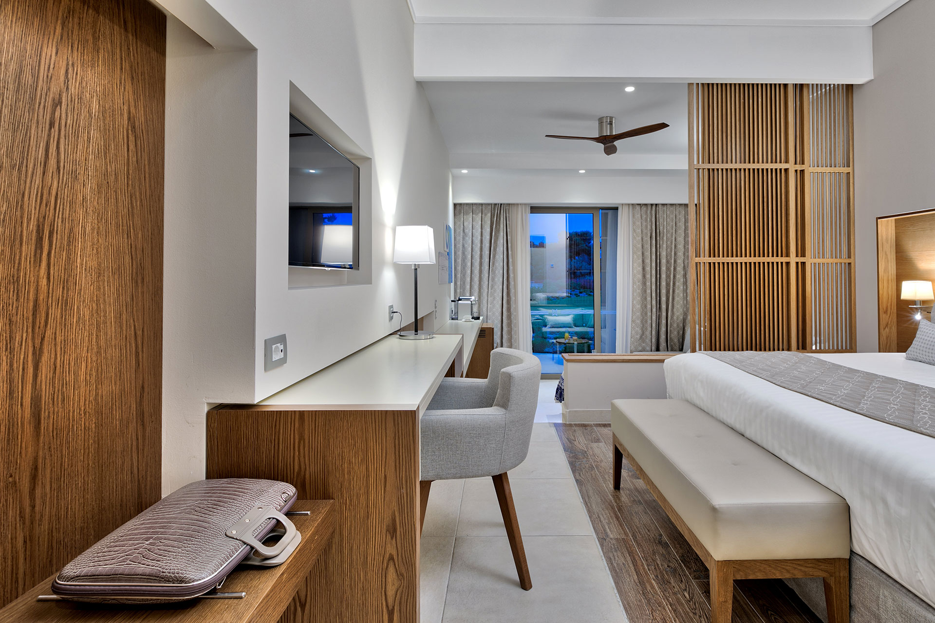 Elegant Family room with modern desk area, soft lighting, and private terrace access