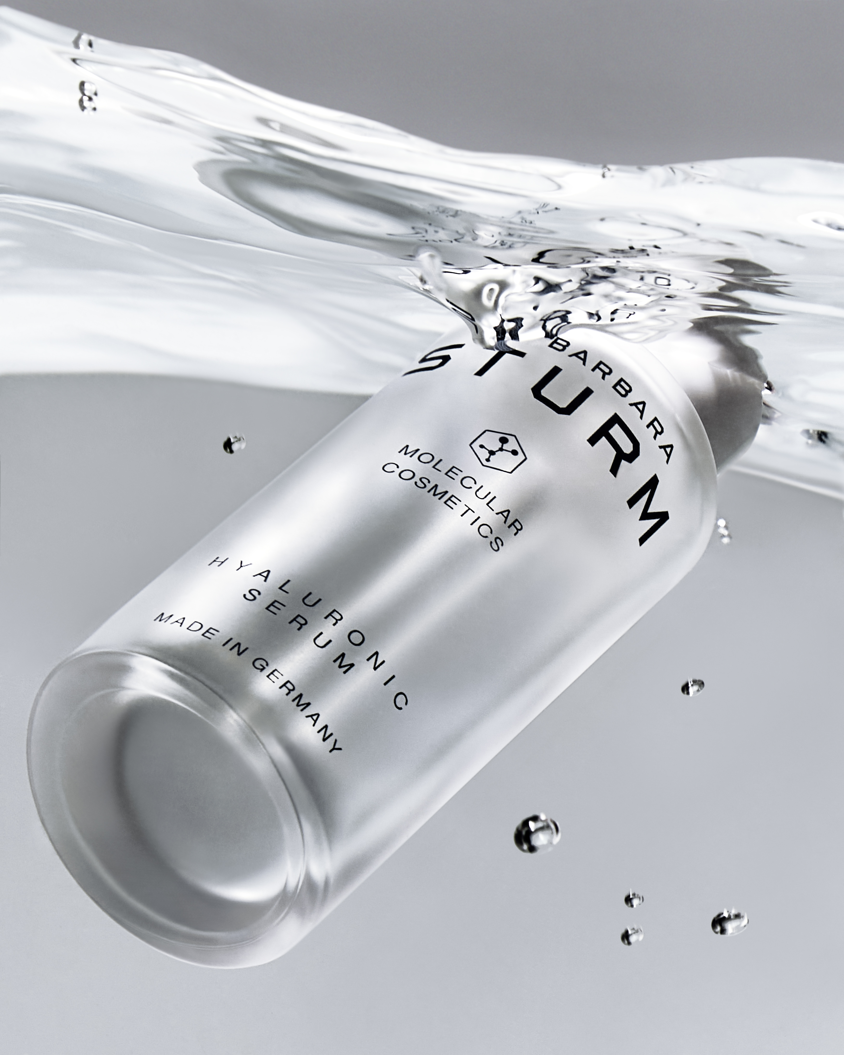 Dr. Barbara Sturm Hyaluronic Serum submerged in clear water, symbolizing deep hydration