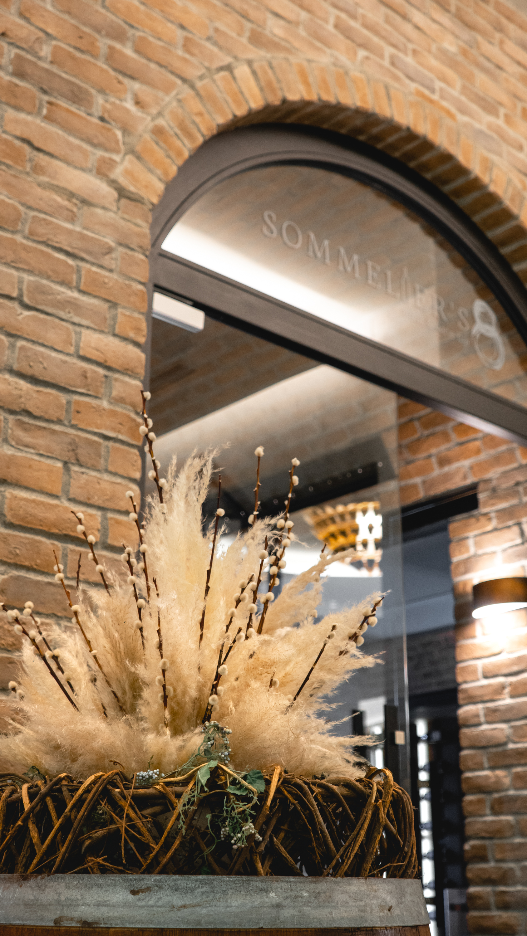 Artistic plant arrangement in root-wrapped pot outside Sommelier's 8 restaurant