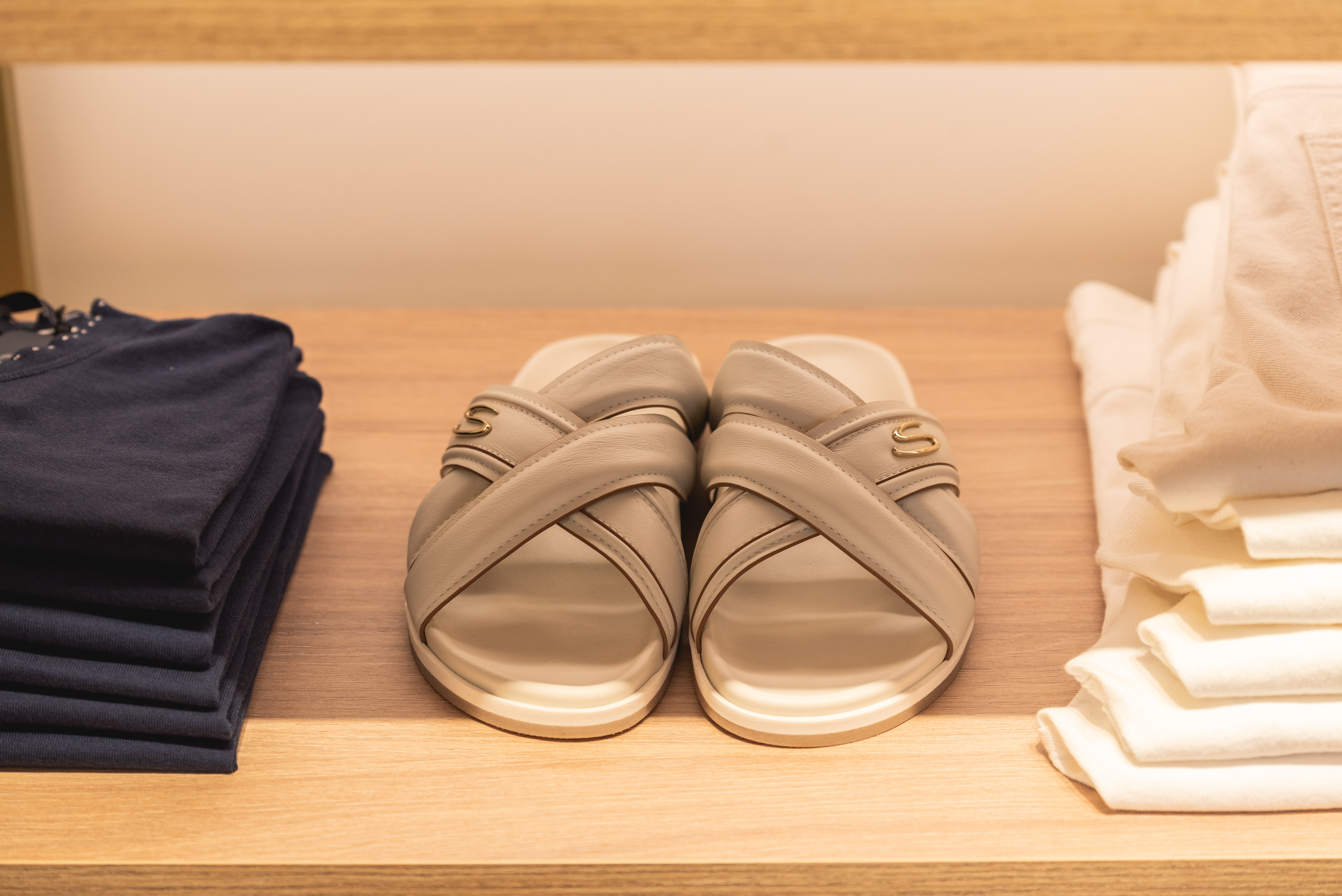 Close up to sandals with elegant design on wooden shelf