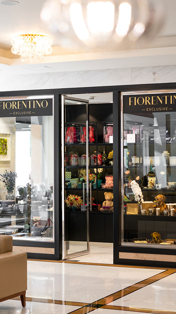 Luxury boutique shop "Fiorentino Exclusive" inside the hotel lobby with elegant marble flooring