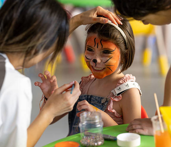 A child being facepainted by Miraggio staff at Kids Planet