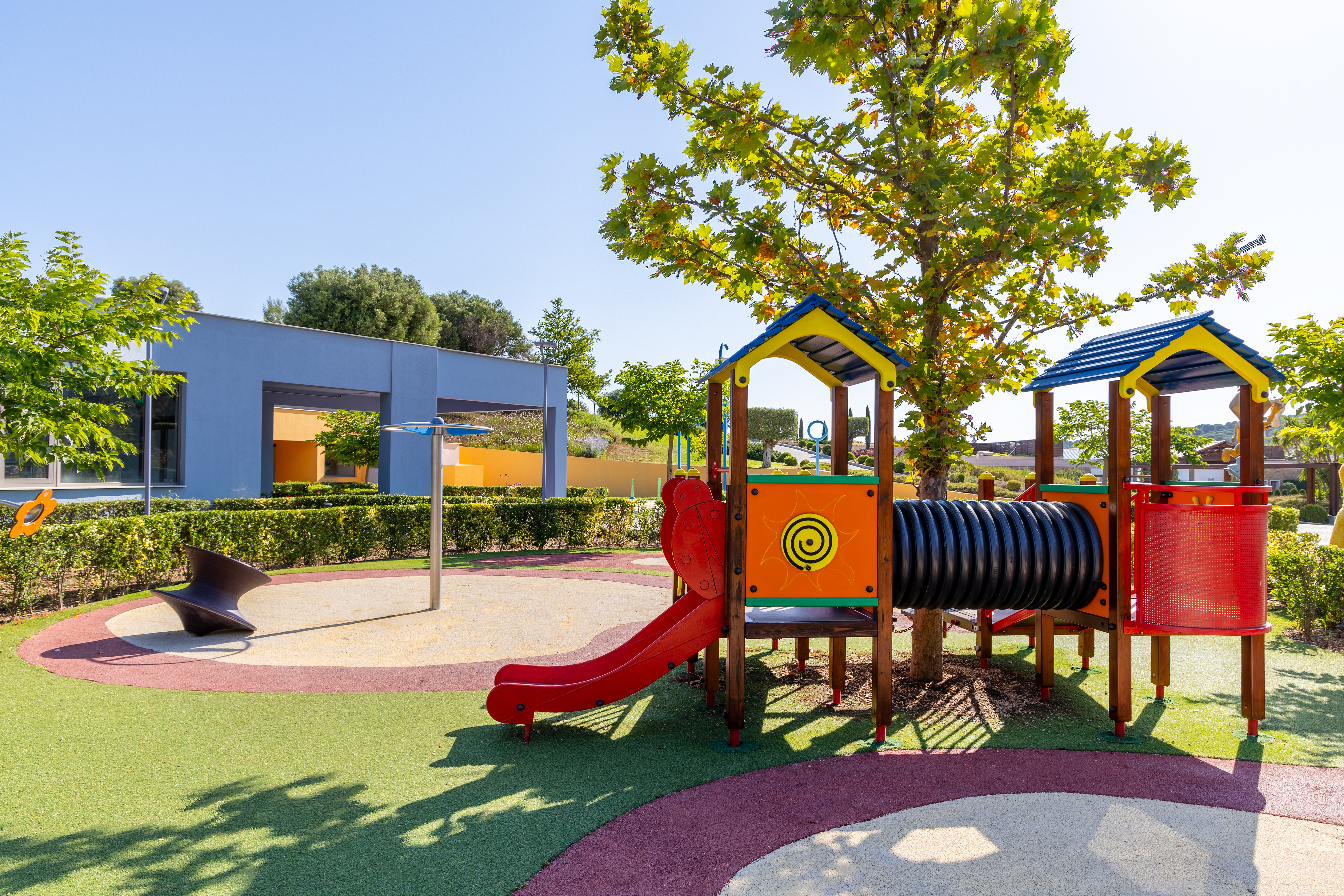 Colorful playground with slide and climbing tunnel at the outdoor Kids Planet